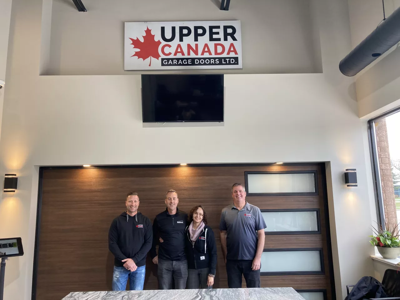 Our team in our showroom with the company logo